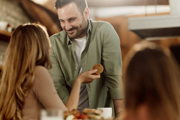 istock Smiling couple in love talking in dining room. 2183218318