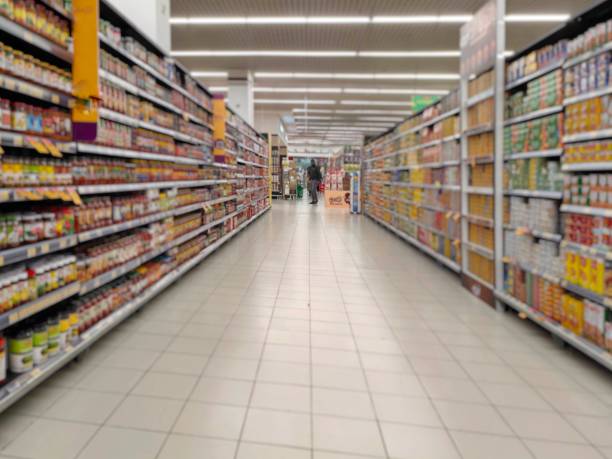 istock Food products, minimums and other basic necessities that have been packaged in cans or plastic are displayed on supermarket shelves. 2183218505