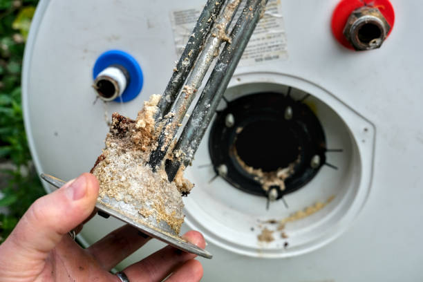 istock Electric water heater heating element, worn and covered with limescale. 2183218636