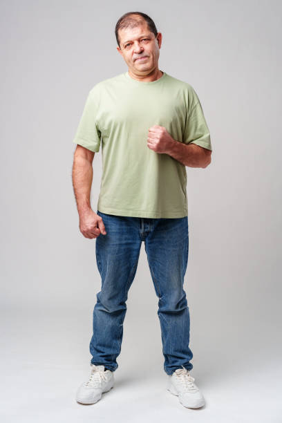 istock A middle-aged man stands confidently in casual attire against a neutral background 2183218802