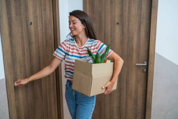 istock Woman holding a box while moving house 2183218875