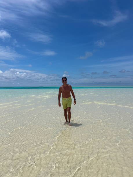 istock Man Walking on a Tropical Sandbar in Clear Waters 2183220833