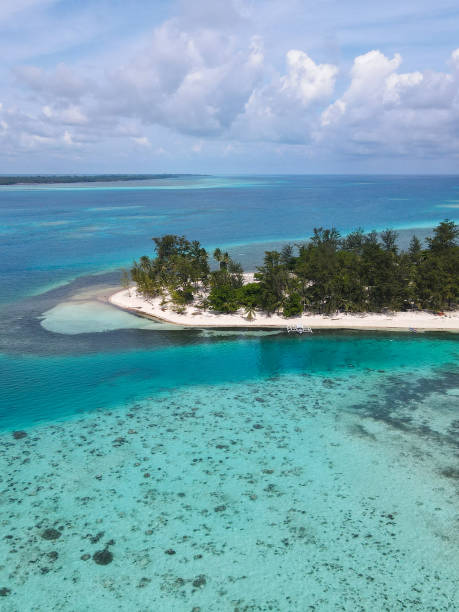istock Remote Island with Crystal-Clear Coral Waters in Tropical Paradise 2183220877