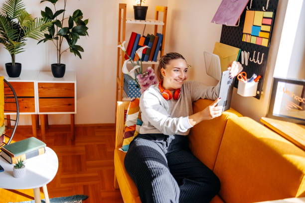 istock Young female adult working home office looking at digital tablet 2183223119