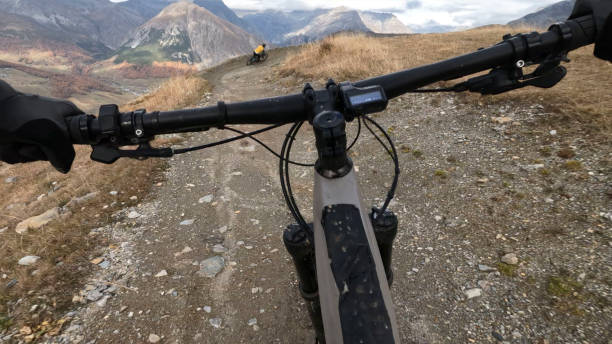 istock POV to mountain biker riding trail in autumn forest 2183226393