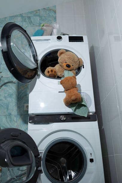 istock An adorable Cute Teddy Bear amusingly situated in a Laundry Machine funfilled scene 2183226453
