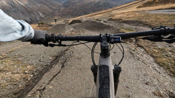 istock POV to mountain biker following friends down mountain trail 2183226467