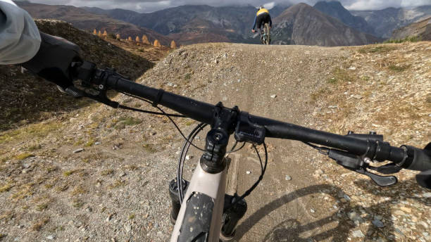 istock POV to mountain biker following friends down mountain trail 2183226518