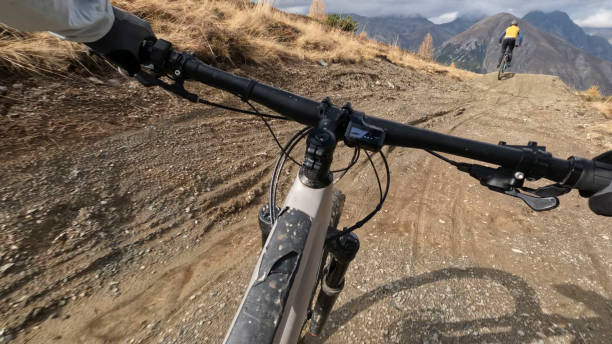 istock POV to mountain biker following friends down mountain trail 2183226540