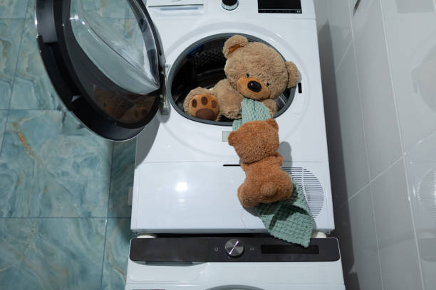 istock A Cute Teddy Bear is Joyfully Playing Inside a Washing Machine, Enjoying the Cozy Space 2183226776