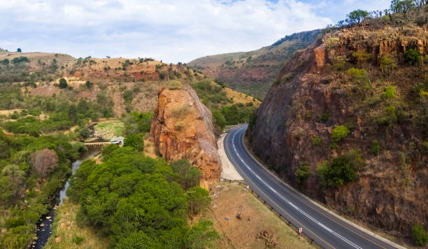 Mountain pass panorama in Mpumalanga with a winding road through a rocky cliff.