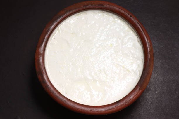 istock milk Curd made in the earthen pot. 2183229627