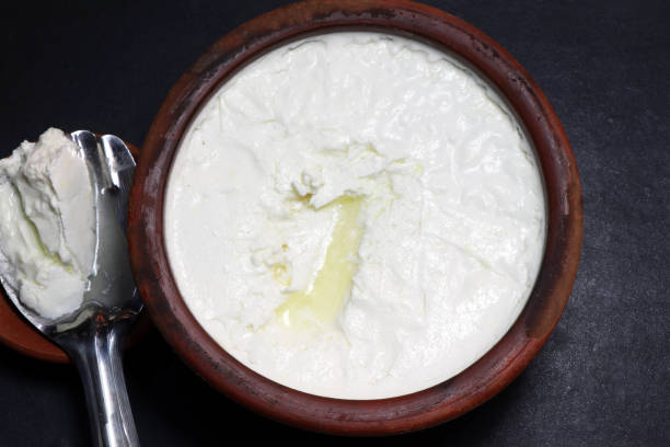 istock milk Curd made in the earthen pot. 2183229632