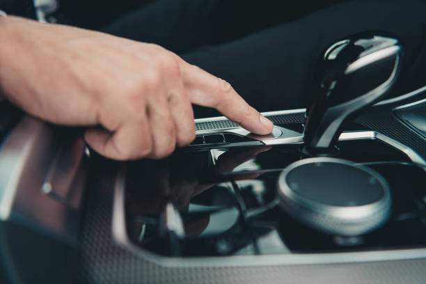 istock Close-up of a hand pressing a button in a car interior, showing modern technology and driving controls 2183232248
