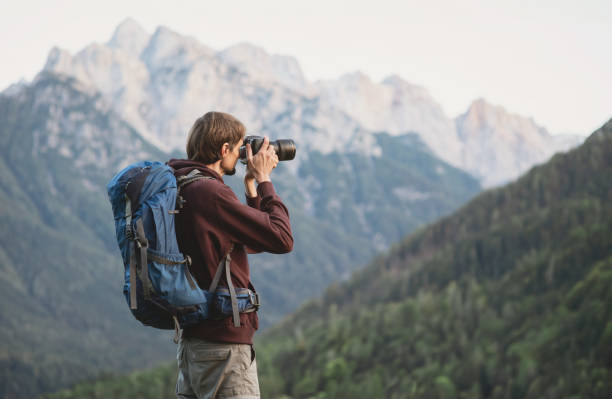 istock Young man photographer taking photographs in a mountains 2183232468