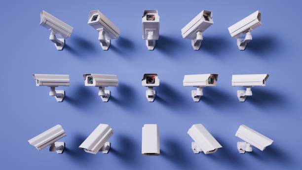 istock Multiple video cameras on a blue wall, focused all directions. Metaphor of total control. Security monitoring. 3d render 2183232542