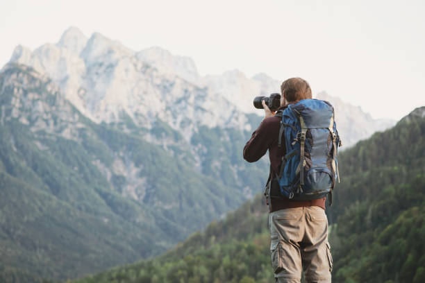 istock Young man photographer taking photographs in a mountains 2183235378