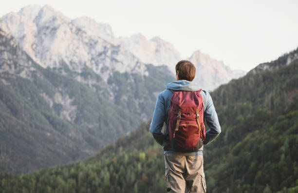 istock Young man traveler in a mountains 2183235393
