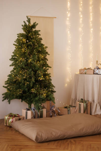 istock Decorated Christmas tree with garland in bright living room 2183236073