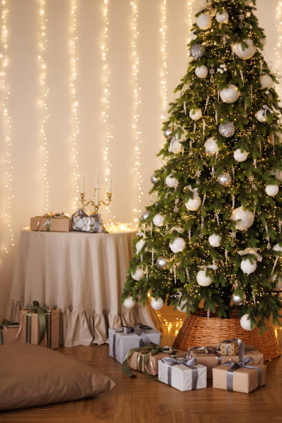 Decorated Christmas tree with garland in bright living room