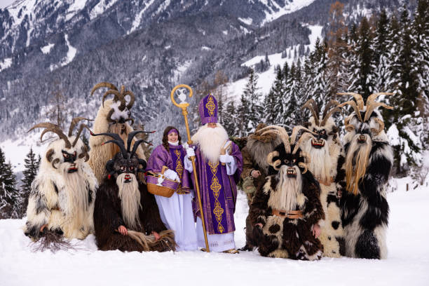 istock St. Nicholas celebration with costumed figures in snowy alpine setting during winter festive traditions 2183237685
