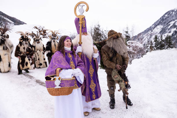 istock Traditional festival featuring St. Nicholas, local folklore characters, and festive activities in a snowy mountain landscape 2183237873