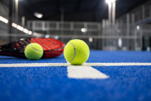 istock Paddle tennis racket and balls on blue turf 2183238626