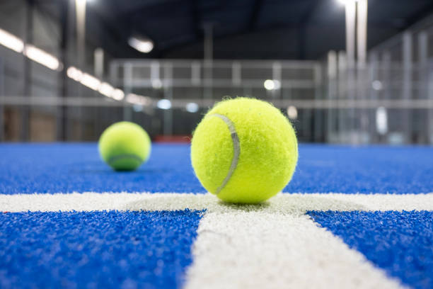 istock Paddle tennis racket and balls on blue turf 2183238651