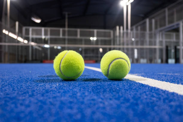 istock Paddle tennis racket and balls on blue turf 2183238677