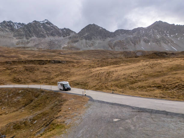 istock Camper Van Navigating Winding Mountain Road in Remote Alpine Region 2183238939