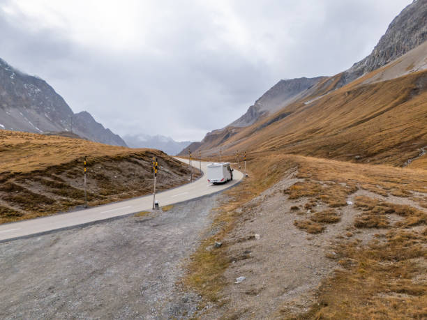 istock Camper Van Navigating Winding Mountain Road in Remote Alpine Region 2183238948