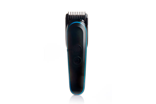 a black electric hair clipper standing on a white background, with some blank space around it