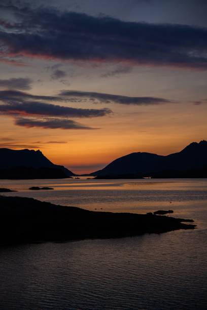 istock Serene sunset over calm sea and mountains 2183240083