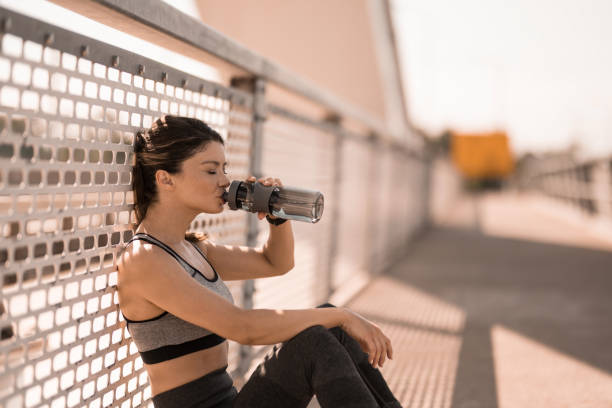 istock Athletic woman drinking water outdoors. 2183243317