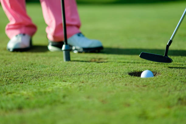 istock A golfer prepares to putt on a well-maintained green during a sunny day at a golf course 2183243634