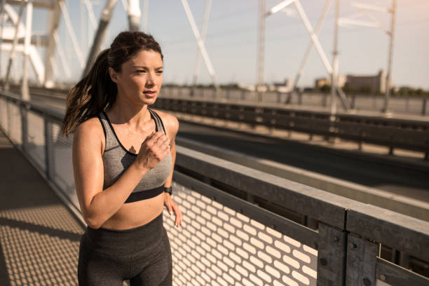 istock Athletic woman running outdoors. 2183244042
