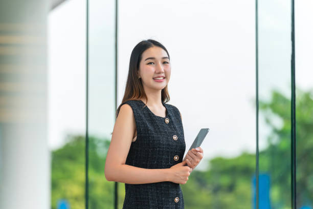 istock Young Businesswoman Holding A Tablet, Looking Away Smiling 2183244512