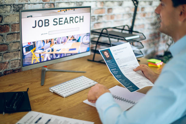 Man holding CV, while searching a new job