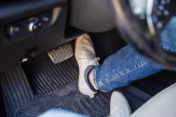 istock Driver's feet pressing gas pedal in car close-up 2183246230