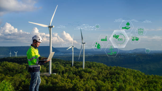 istock Engineers are using notebooks to analyze energy from electric wind turbines to reduce pollution, green technology. caring for the environment and sustainable development signs with icons 2183246532
