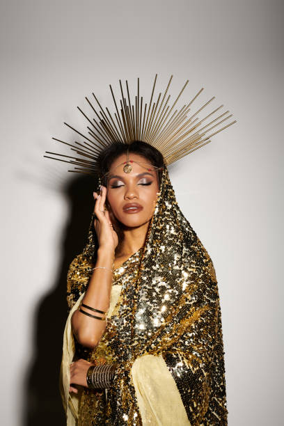 istock Elegant Black goddess in a sequined dress and crown in a studio setting 2183246699