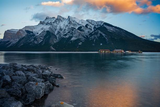 istock Snow-capped mountains and tranquil lake at sunset. 2183246747