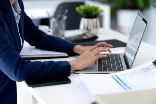 istock Young business woman is typing data using a computer to do business 2183247147