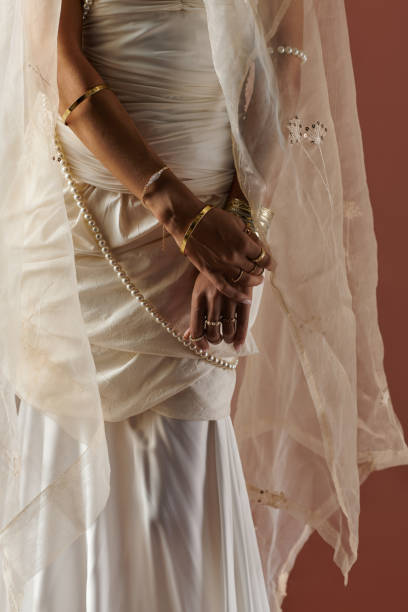 istock A captivating bride in a white dress and pearl necklace poses gracefully in a studio setting 2183248454