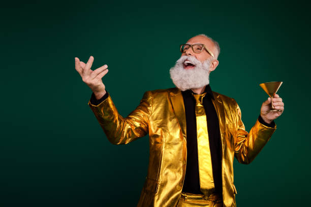 istock Joyful elderly gentleman in elegant golden suit celebrating a glamorous event 2183248855
