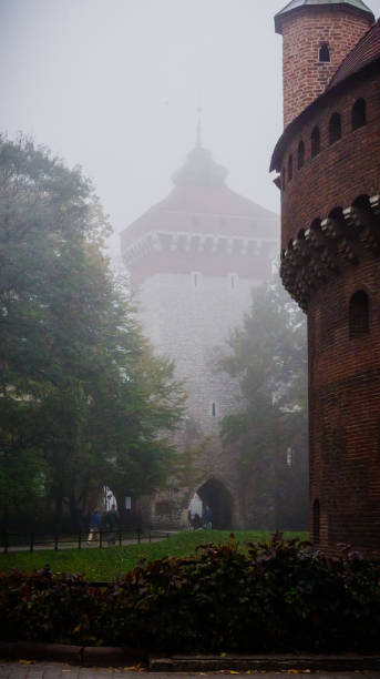 Saint Canute's Cathedral. Aerial view from Odense city center. Foggy morning with clouds hanging low while the sun is rising