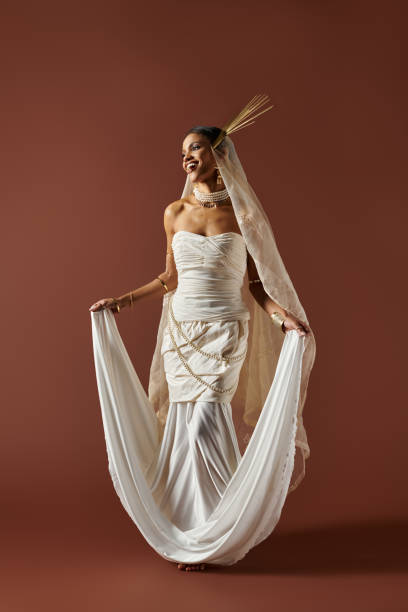 istock Elegant bride in a white dress with pearls against a rich brown backdrop 2183249232