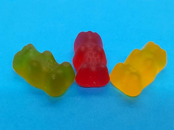 istock 3 gummy candies with blue background 2183249741