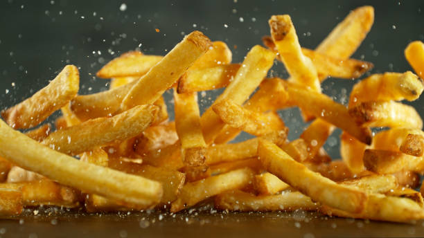 istock French fries - fried potatoes flying. 2183249983