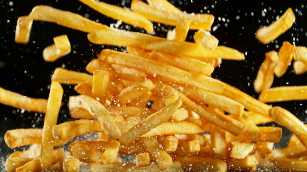 istock French fries - fried potatoes flying. 2183250005